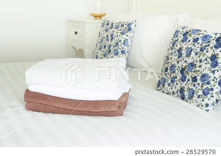 White and brown towels on clean bed with double pi 26529570