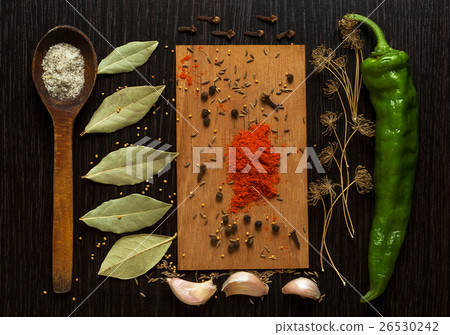 Stock Photo: A set of spices and herbs on black wooden board