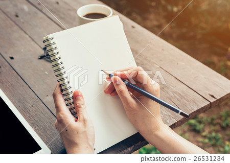 Young business woman hand with pencil writing 26531284