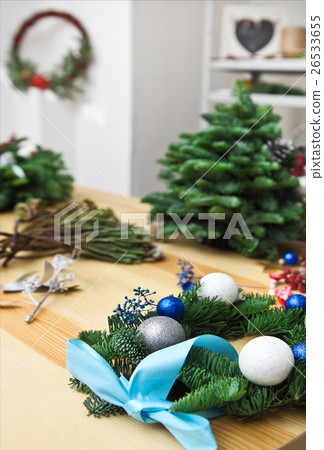 Decorating Christmas wreath on the table 26533655