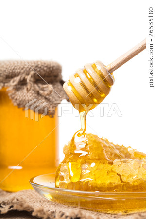 Honey dripping from wooden spoon Honey dripping from wooden spoon 26535180
