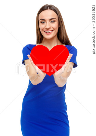 Beautiful woman holding heart shaped gift Beautiful woman holding heart shaped gift 26535622