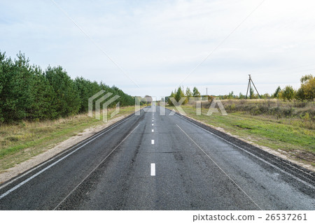 Asphalt highway with white intermittent markings Asphalt highway with white intermittent markings 26537261