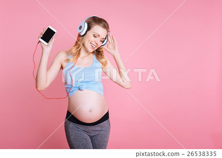 Positive delighted pretty woman listening to music 26538335