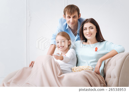 Cheerful tolerant family watching news 26538953