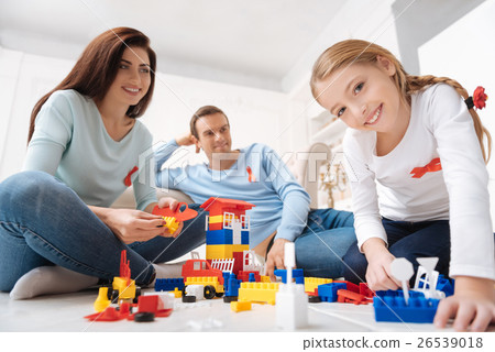 Joyful delighted family sitting around the meccano 26539018