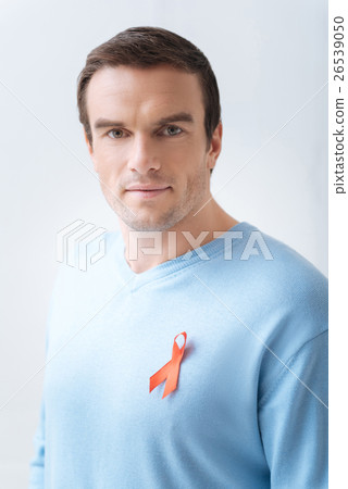 Good looking confident man wearing red AIDS ribbon Good looking confident man wearing red AIDS ribbon 26539050