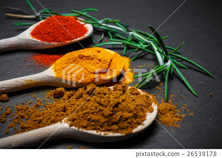 spices in wooden spoons over black spices in wooden spoons over black 26539178