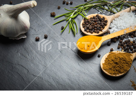 Stock Photo: spices and herbs over black stone background