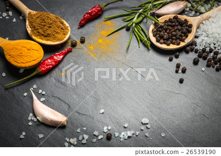 Stock Photo: spices and herbs over black stone background