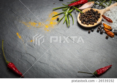 spices and herbs over black stone background spices and herbs over black stone background 26539192