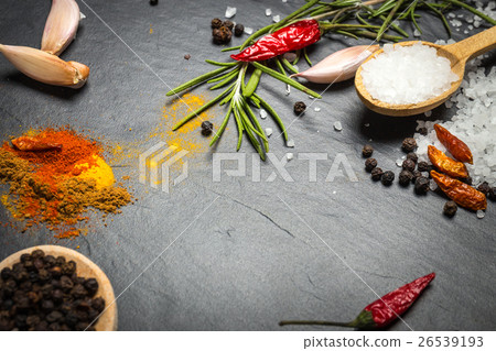 Stock Photo: spices and herbs over black stone background