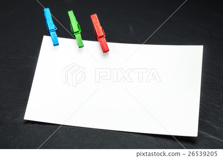 close up of a note paper and clothes pegs  26539205