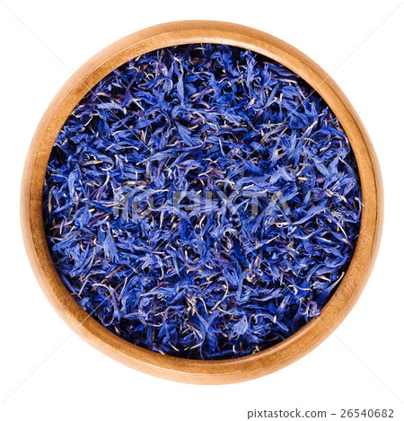 Dried cornflowers in wooden bowl over white Dried cornflowers in wooden bowl over white 26540682