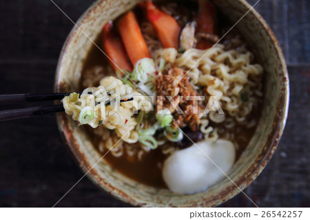Noodles with egg spicy soup on wood background Noodles with egg spicy soup on wood background 26542257