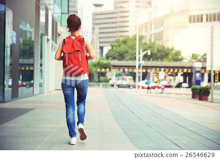 young asian woman walking on city street young asian woman walking on city street 26546629