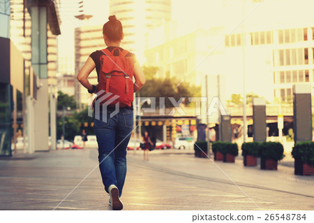 young asian woman walking on city street young asian woman walking on city street 26548784