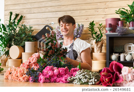 Stock Photo: Man florist assistant in flower shop delivery make