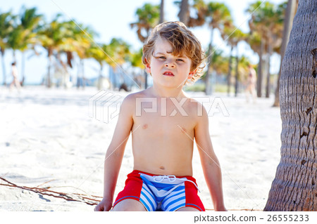 Little kid boy having fun on tropical beach 26555233