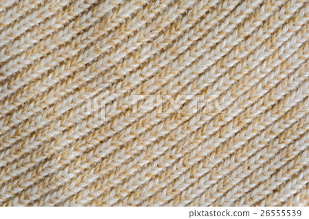 Closeup of beige knitted woolen fabric texture Closeup of beige knitted woolen fabric texture 26555539