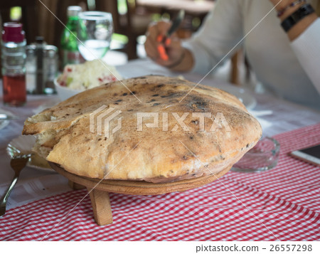 Pitta bread on the red dining table close up. Pitta bread on the red dining table close up. 26557298
