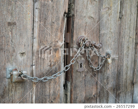 Background of an old brown wooden gate close up. Background of an old brown wooden gate close up. 26557299