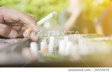 Man smoking cigarettes. Man smoking cigarettes. 26559478