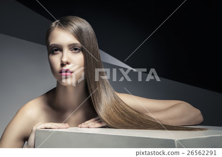 Calm young woman with  shiny hair looking away 26562291