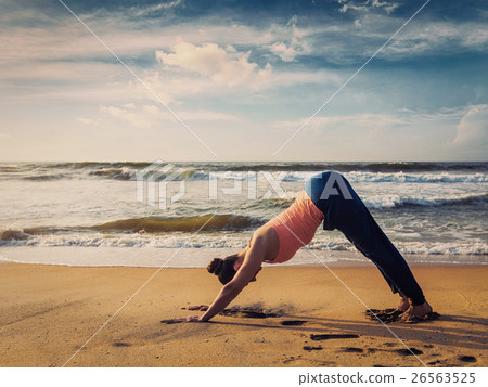 Young sporty fit woman doing yoga oudoors at 26563525
