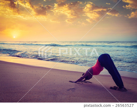 Young sporty fit woman doing yoga at beach on Young sporty fit woman doing yoga at beach on 26563527
