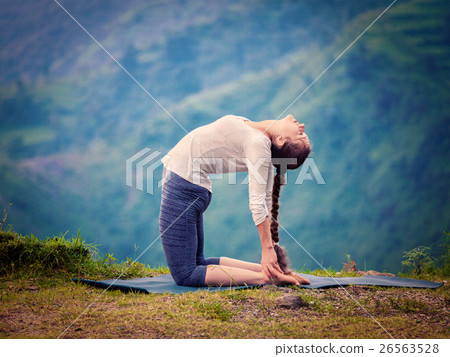 Woman doing yoga asana Ustrasana camel pose Woman doing yoga asana Ustrasana camel pose 26563528