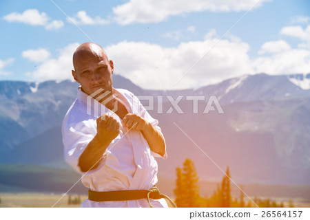 Man in white kimono and black belt training kung Man in white kimono and black belt training kung 26564157