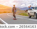 Man rides a longboard in the mountains. Near 26564163