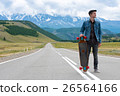 Longboarder posing beside his longboard skateboard 26564166