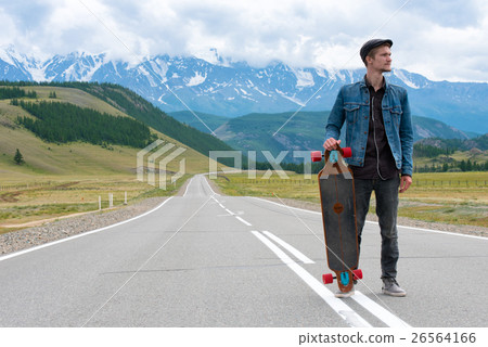 Longboarder posing beside his longboard skateboard Longboarder posing beside his longboard skateboard 26564166