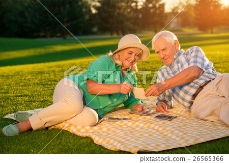 Senior people lying on meadow. 26565366