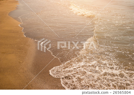 Foamy water on a shore. 26565804