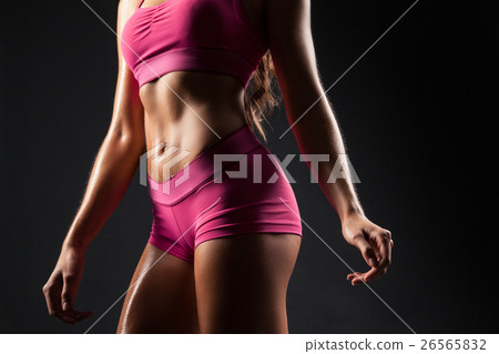 Crop sportive female posing seductively 26565832