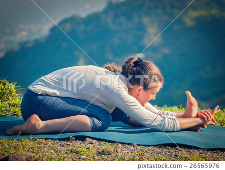 Woman in Tiryam-Mukha Eka-Pada Paschimottanasana 26565976
