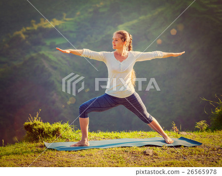 Woman doing yoga asana Virabhadrasana 2 - Warrior Woman doing yoga asana Virabhadrasana 2 - Warrior 26565978