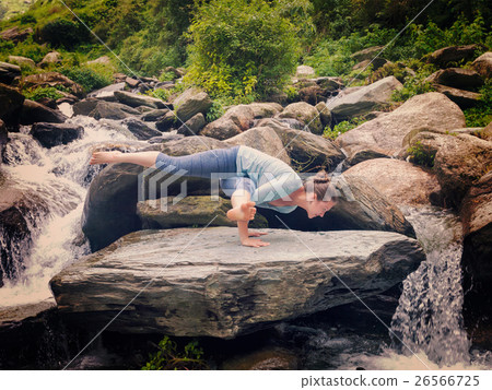 Young sporty fit woman doing yoga oudoors at 26566725