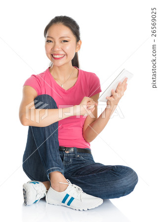 Young Asian female student using tablet pc Young Asian female student using tablet pc 26569025