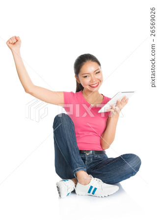 Young Asian teen student using tablet pc Young Asian teen student using tablet pc 26569026