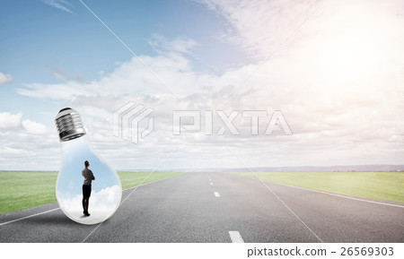 Businesswoman inside light bulb Businesswoman inside light bulb 26569303