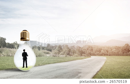 Businessman inside light bulb Businessman inside light bulb 26570519