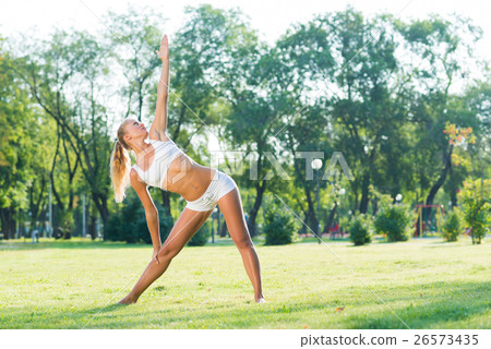 woman doing yoga in the park 26573435