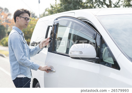 A man riding a car 26579993