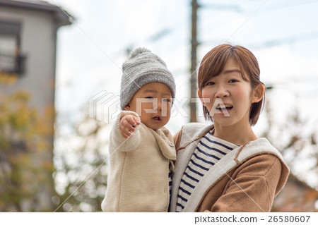 Babies and moms playing in the park 26580607