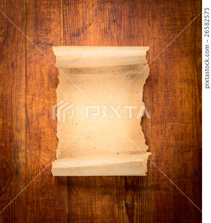 parchment scroll on wooden background 26582575