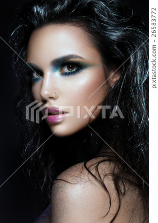 Beautyful girl with blue glitter on her face 26583772